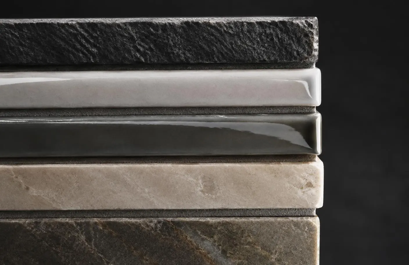 Stacked tile edges showing matte stone, glazed and honed marble finishes